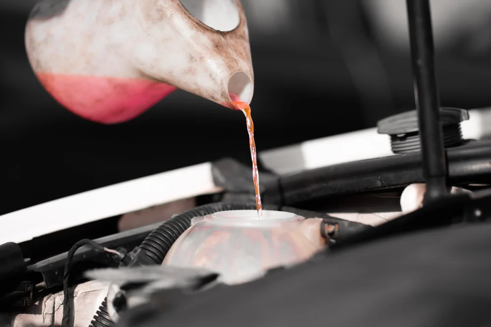 Engine fluid being poured into a diesel vehicle